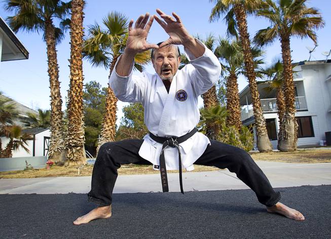 Karate master Dan Sawyer demonstrates his form at his home Sunday, Jan. 27, 2013. Sawyer teaches in a garage behind his home that has been converted into a karate dojo.