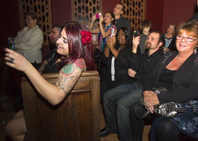 Friends and family members take photos as Anthony Gallegos and Rosie Grasso of Las Vegas get married in the chapel at Eli Roths Goretorium Sunday, Jan. 27, 2013.