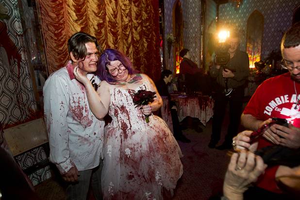 Anthony Gallegos and Rosie Grasso of Las Vegas pose for photos in a wedding reception area after getting married at Eli Roths Goretorium Sunday, Jan. 27, 2013.