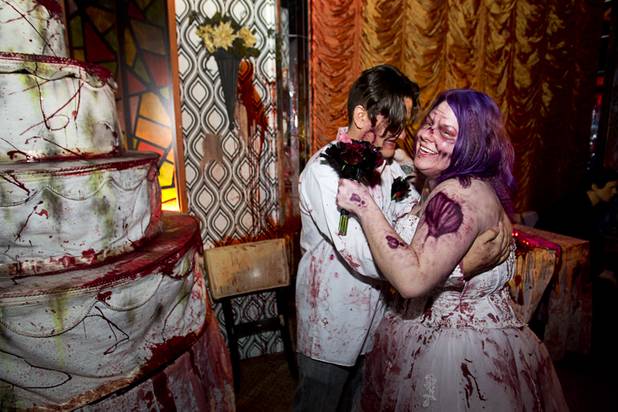 Anthony Gallegos and Rosie Grasso of Las Vegas pose for photos in a wedding reception area after getting married at Eli Roth's Goretorium on Sunday, Jan. 27, 2013.