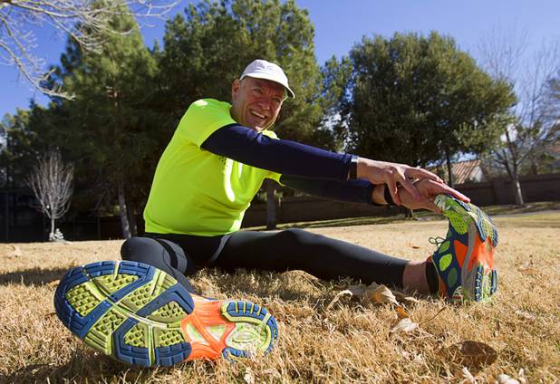 Mark Noel stretches out before training along the Pittman Wash in Henderson Sunday, Jan. 27, 2013. Noel, at one time weighed more than 400 pounds, but now weighs 185 pounds and is running in the Surf City USA Marathon in California on Feb 3.
