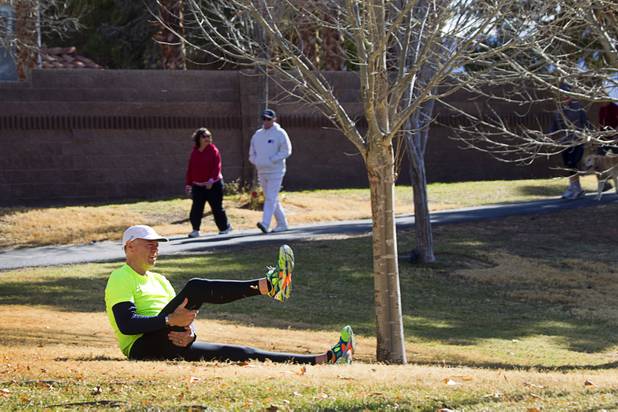 Mark Noel stretches out before training along the Pittman Wash in Henderson Sunday, Jan. 27, 2013. Noel, at one time weighed more than 400 pounds, but now weighs 185 pounds and is running in the Surf City USA Marathon in California on Feb 3.
