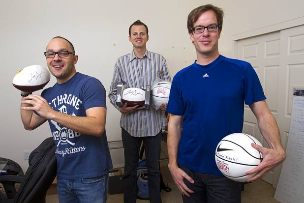 Darren Flores, left, content manager, and company co-founders Tom Ellinson, center, and Dean Curtis pose at the Fandeavor offices in the Ogden in downtown Las Vegas Monday, Jan. 28, 2013. Fandeavor is a sports marketing group that sells special game-day packages to fans.