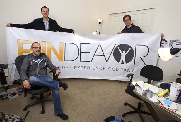Company co-founders Tom Ellinson, left, and Dean Curtis pose with content manager Darren Flores, seated, at the Fandeavor offices in the Ogden in downtown Las Vegas Monday, Jan. 28, 2013. Fandeavor is a sports marketing group that sells special game-day packages to fans.