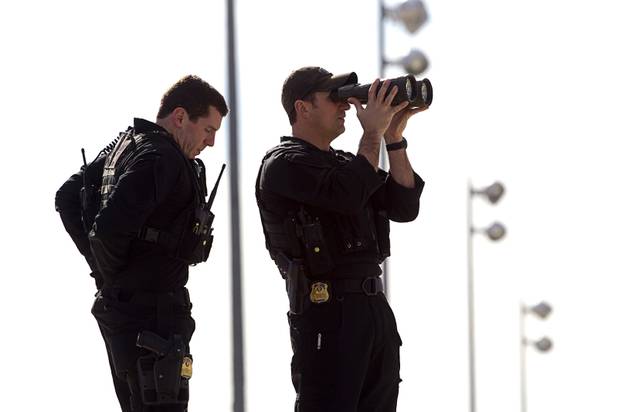 A security team surveys the area as they wait  for President Barack Obama  to at McCarran International Airport  in Las Vegas, Nevada Tuesday, Jan. 29, 2013.