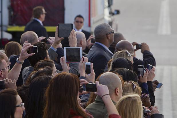 Guests take photos as Air Force One taxis at McCarran International Airport in Las Vegas, Nevada Tuesday, Jan. 29, 2013.