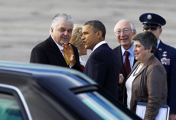 President Barack Obama talks with Clark County Commission Chairman Steve Sisolak, left, as he arrives to kick off his public push for immigration reform in Las Vegas, Nevada Tuesday, Jan. 29, 2013.