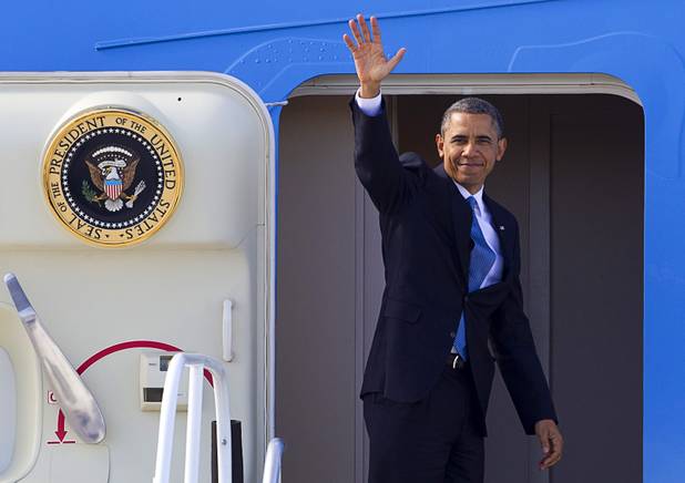 President Barack Obama waves from Air Force One at McCarran International Airport after to kicking off his public push for immigration reform in Las Vegas, Nevada Tuesday, Jan. 29, 2013.