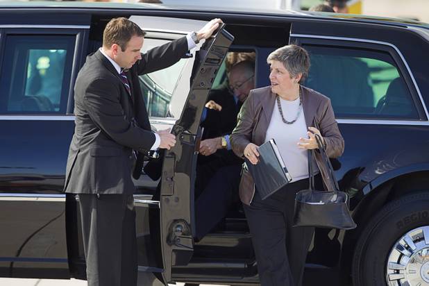 Janet Napolitano, secretary of Homeland Security, and Ken Salazar, secretary of the Interior, exit a presidential limousine at McCarran International Airport, after President Barack Obama kicked off his public push for immigration reform in Las Vegas, Nevada Tuesday, Jan. 29, 2013.