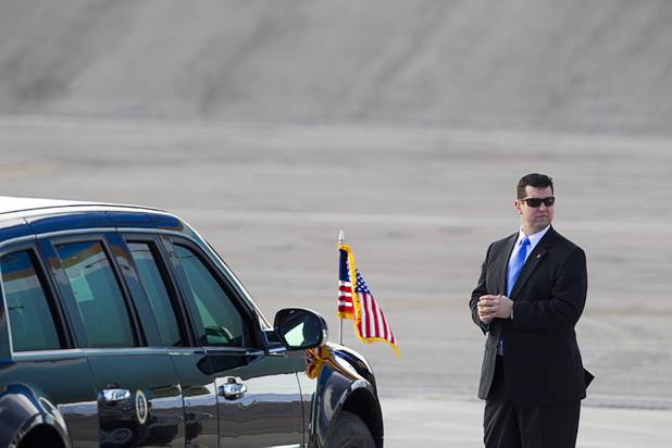 An agent stands by a presidential limousine as President Barack Obama prepares to leave McCarran International Airport after to kicking off his public push for immigration reform in Las Vegas, Nevada Tuesday, Jan. 29, 2013.