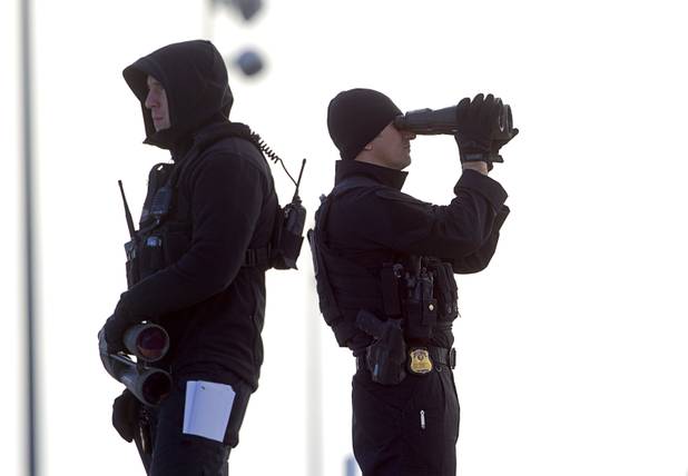 A security team keeps an eye on things as President Barack Obama prepares to leave McCarran International Airport after to kicking off his public push for immigration reform in Las Vegas, Nevada Tuesday, Jan. 29, 2013.