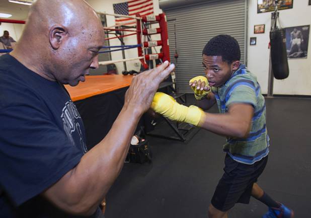 Former boxing referee Richard Steele works with Sha'Rhod Williams, 17, at the Richard Steele Boxing Club in North Las Vegas Tuesday, Jan. 29, 2013.