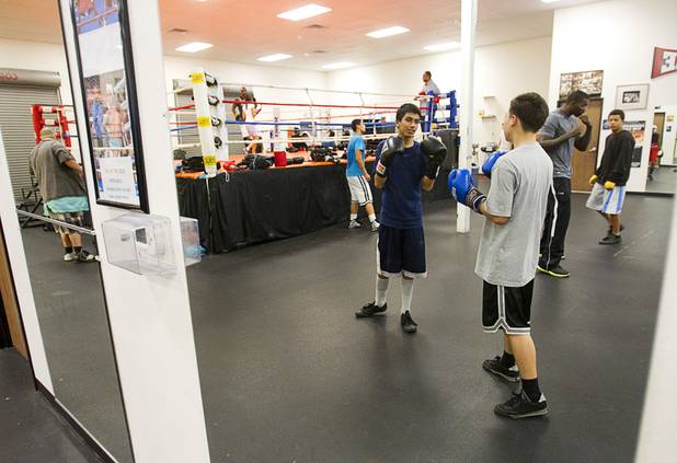 Boxing students are reflected in mirrors as they work out at the Richard Steele Boxing Club in North Las Vegas Tuesday, Jan. 29, 2013.
