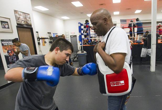 Elmer Cornavaca, 15, works out with volunteer coach Jimmie Gathrite at the Richard Steele Boxing Club in North Las Vegas Tuesday, Jan. 29, 2013.