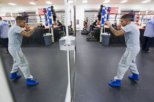 Christian Mendiola, 19, shadow boxes in front of a mirror at the Richard Steele Boxing Club in North Las Vegas Tuesday, Jan. 29, 2013.