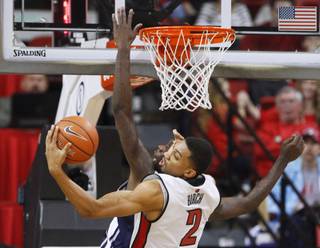 UNLV forward Khem Birch grabs a rebound from UNR guard Jerry Evans Jr. during their game Tuesday, Jan. 29, 2013 at the Thomas & Mack. UNLV won the game 66-54.