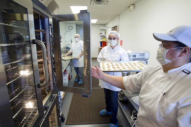 Jane Lee, right, owner and president of Jadon Foods, holds an oven door for Ahsley Money at the bakery with a tray of gluten-free cookies Wednesday, Jan. 30, 2013. Jadon Foods is a gluten-free bakery that also specializes in diabetic-friendly and dairy-free baked goods.