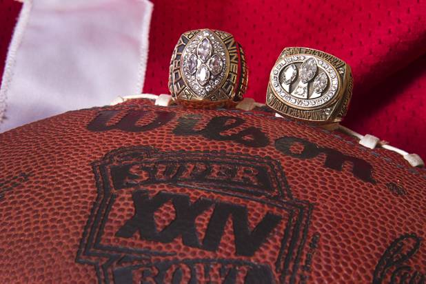 Memorabilia is displayed at Mike Cofer's home in Henderson Wednesday, Jan. 30, 2013. Cofer was a NFL kicker and played with the San Francisco 49ers during Super Bowl wins in 1989 and 1990. The rings are from XXIV, left, and XXIII.