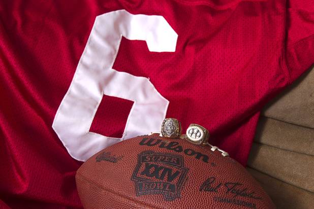Memorabilia is displayed at Mike Cofer's home in Henderson Wednesday, Jan. 30, 2013. Cofer was a NFL kicker and played with the San Francisco 49ers during Super Bowl wins in 1989 and 1990. The rings are from XXIV, left, and XXIII.