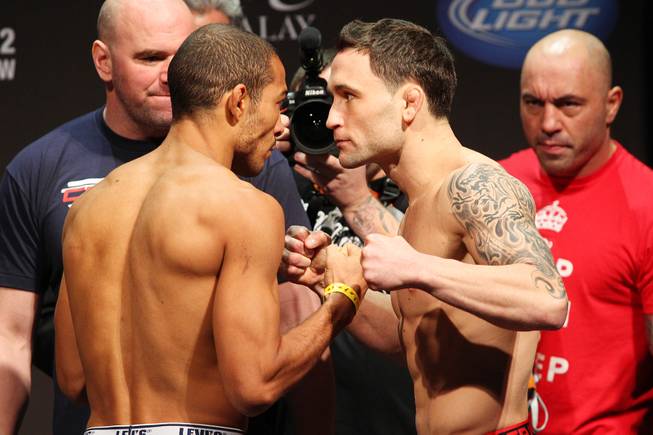 Lightweight champion Jose Aldo, left, and challenger Frankie Edgar face off during weigh ins for UFC 156 Friday, Feb. 1, 2013.