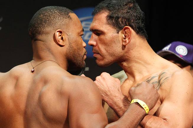 Light heavyweights Rashad Evans, left, and Antonio Rogerio Nogueira face off during weigh ins for UFC 156 Friday, Feb. 1, 2013.