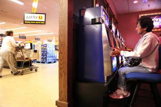 A woman, who did not want her name used, plays slots in the Golden Gaming area inside a Vons Supermarket in Las Vegas on Friday, February  1, 2013.