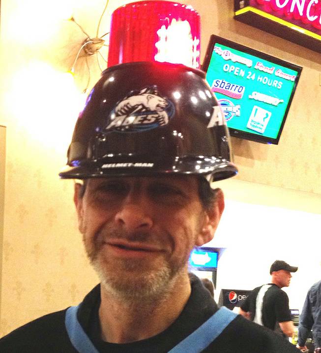 Alaska Aces fan Rick White proudly wears his gear that earned him the nickname "Helmet Man," Friday, Feb. 1, 2013, at the Orleans Arena. The Wranglers topped the aces 5-4.