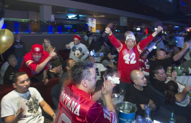 San Francisco 49er fans from the Bay Area cheer an early touchdown against the Baltimore Ravens during a Super Sunday party at the Sapphire Las Vegas strip club Sunday, Feb. 3, 2013.