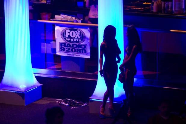 Women talk by lighted columns during a Super Sunday party at the Sapphire Las Vegas strip club Sunday, Feb. 3, 2013.