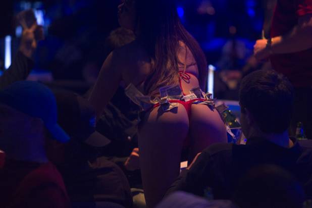 A stripper gives a lap dance during halftime at a Super Sunday party at the Sapphire Las Vegas strip club Sunday, Feb. 3, 2013.