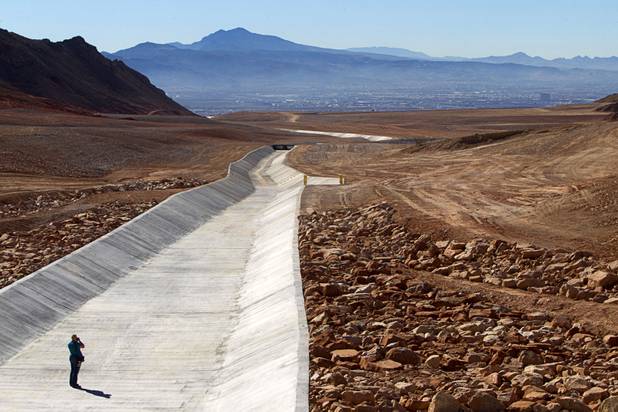 A news photographer takes a photo of a flood control channel during a tour of Sunrise Landfill Tuesday, Feb. 5, 2013. In 1998, a storm damaged the landfill cap, sending waste into the Las Vegas Wash and Lake Mead. The tour marked the completion of $36 million in storm control construction.