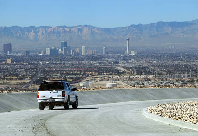 A sport utility vehicle drives down a paved channel on the Sunrise Landfill during a media tour Tuesday, Feb. 5, 2013. In 1998, a storm damaged the landfill cap, sending waste into the Las Vegas Wash and Lake Mead. The tour marked the completion of $36 million in storm control construction.