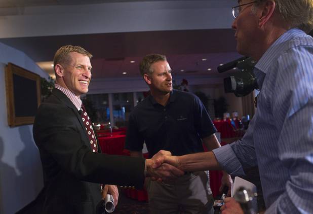 UNLV football coach Bobby Hauck, left, talks with reporters after a news conference where he announced the Rebels' 2013 recruiting class at the Thomas & Mack Center Wednesday, February 6, 2013. 