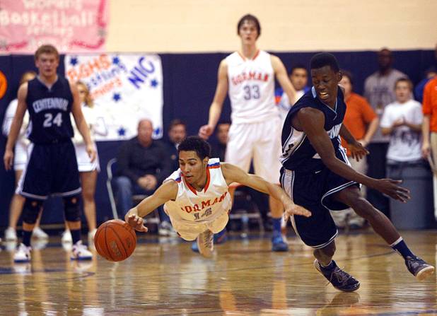 Awarded second place in "Best Sports Photo" category by the Nevada Press Association. Bishop Gorman's Noah Robotham, left, dives for a loose ball during a game against Centennial High School at Bishop Gorman Thursday, Feb. 7, 2013. Centennial's Malcolm Allen is at right. Bishop Gorman beat Centennial 79-71 in double overtime.