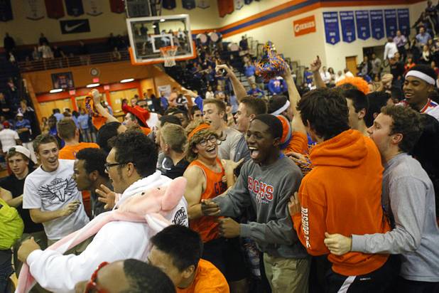 Bishop Gorman fans celebrate on the court after their team beat Centennial High School in double overtime at Bishop Gorman Thursday, Feb. 7, 2013.