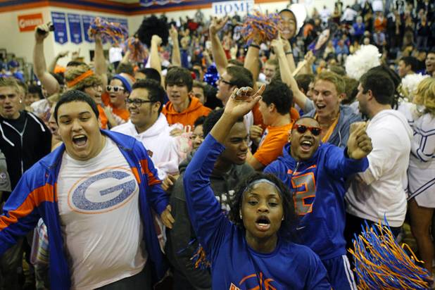Bishop Gorman fans celebrate on the court after their team beat Centennial High School in double overtime at Bishop Gorman Thursday, Feb. 7, 2013.