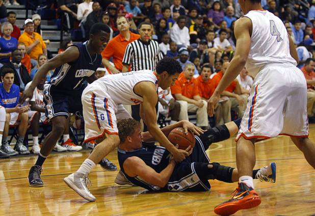 Bishop Gorman's Noah Robotham, left, tries to take the ball from Centennial's Austin Turley at Bishop Gorman Thursday, Feb. 7, 2013. Bishop Gorman beat Centennial 79-71 in double overtime.