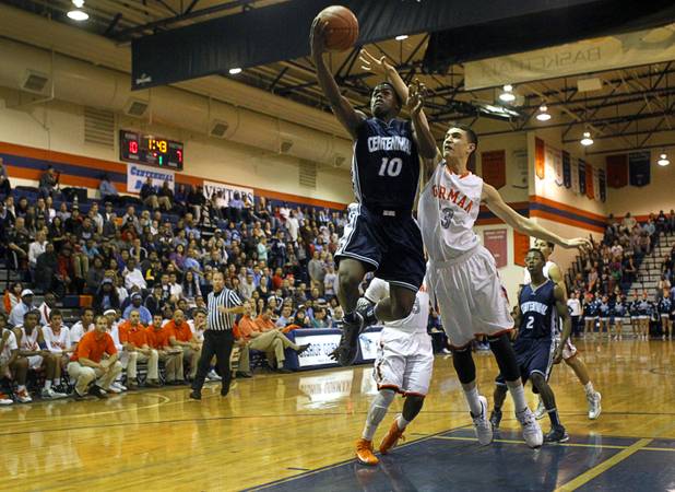 Centennial High School's Marcus Allen lays up the ball  as Bishop Gorman's Orr Leumi defends at Bishop Gorman Thursday, Feb. 7, 2013. Bishop Gorman beat Centennial 79-71 in double overtime.