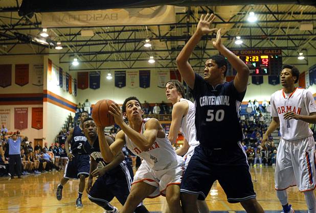 Bishop Gorman's Trey Kennedy, left, is covered by Centennial High School's Eddie Davis at Bishop Gorman Thursday, Feb. 7, 2013. Bishop Gorman beat Centennial 79-71 in double overtime.