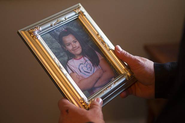 Former Metro Police Lt. Randy Sutton holds a portrait of Jackie, at about age 12, at his home Thursday, Feb. 7, 2013. Sutton is credited with saving Jackie's life when she was shot in 1998. He also helped raise money for her reconstructive surgeries. Sutton is now working on a website called "celebrating legacy.com,"  a social directory that invites members to record and share memories about themselves, family members and their ancestors.