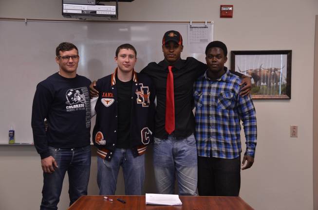 Members of the Legacy High football team are photographed after signing their letters-of-intent. They include: Randy Ricks (San Diego State), Joe Murray (Colorado School of the Mines),  Jake Martin (Coast Guard Academy) and Chris Campbell (Dixie State College).
