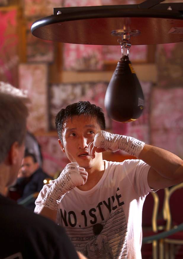 Chinese light flyweight boxer Zou Shiming hits a speed bag during a workout in a training facility at the Palazzo in Las Vegas, Nevada February 8, 2013. Zou, a two-time Olympic gold medalist and three-time world amateur champion, will make his professional debut April 6 at the Venetian Macao Resort in Macau.