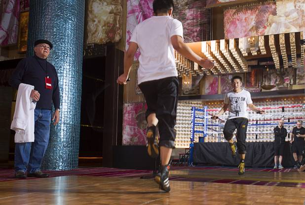 Chinese light flyweight boxer Zou Shiming jumps rope during a workout in a training facility at the Palazzo in Las Vegas, Nevada February 8, 2013. Assistant Miguel Diaz looks on at left. Zou, a two-time Olympic gold medalist and three-time world amateur champion, will make his professional debut April 6 at the Venetian Macao Resort in Macau.