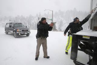 California Highway Patrol officers search a truck for former Los Angeles police officer Christopher Dorner at a checkpoint near Big Bear Lake, Calif., on Friday, Feb. 8, 2013.