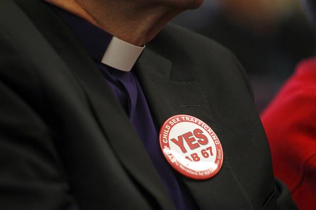 Bishop Dan Edwards of the Episcopal Diocese of Nevada wears a button during a news conference at the State Legislature in Carson City Monday, Feb. 11, 2013. Nevadans for the Common Good, a coalition of faith-based organizations, are learning about the legislative process as they lobby for Assembly Bill 67. The bill would strengthen the laws against sex traffickers.