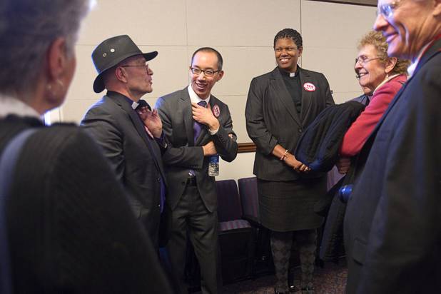 Organizer Robert Hoo, center, listens to comments from Nevadans for the Common Good after a news conference at the State Legislature in Carson City Monday, Feb. 11, 2013. The group, a coalition of faith-based organizations, are learning about the legislative process as they lobby for Assembly Bill 67. The bill would strengthen the laws against sex traffickers.