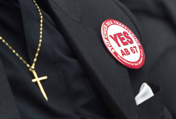 Rev. Dennis Hutson of Advent United Methodist Church in Las Vegas, wears a button in support of Assembly Bill 67 at the State Legislature in Carson City Monday, Feb. 11, 2013. Nevadans for the Common Good, a coalition of faith-based organizations, are learning about the legislative process as they lobby for AB 67. The bill would strengthen the laws against sex traffickers.