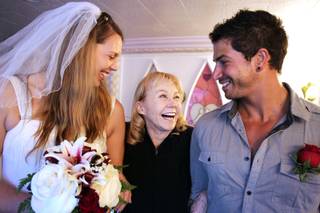 Charolette Richards, center, the owner of A Little White Wedding Chapel, laughs with newly married couple Elizabeth Hooker and Johnny Mitchell of Hong Kong inside the chapel in Las Vegas on Tuesday, February 12, 2013.