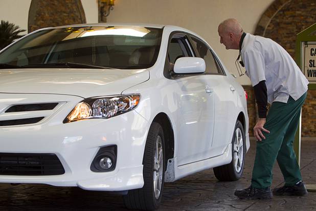 Valet attendant Leo Heffner talks with a driver who needed directions at the El Cortez porte cochere in downtown Las Vegas Wednesday, Feb.13, 2013.