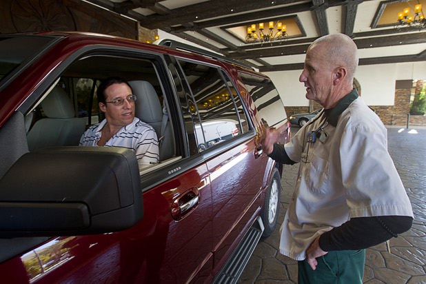 Valet attendant Leo Heffner talks with a Don "Smitty" Smith of Canada who was checking in at the El Cortez in downtown Las Vegas Wednesday, Feb.13, 2013.